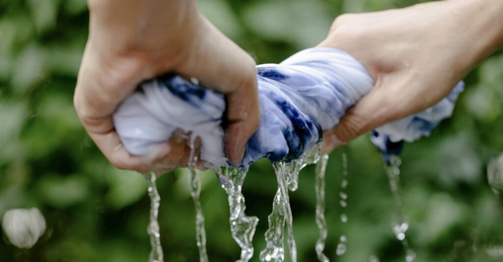 rinsing a stained garment out